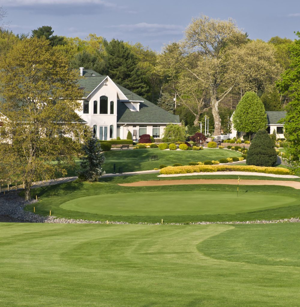 This photo is an exterior shot of the clubhouse and some of the fairway at the Bella Vista Country Club